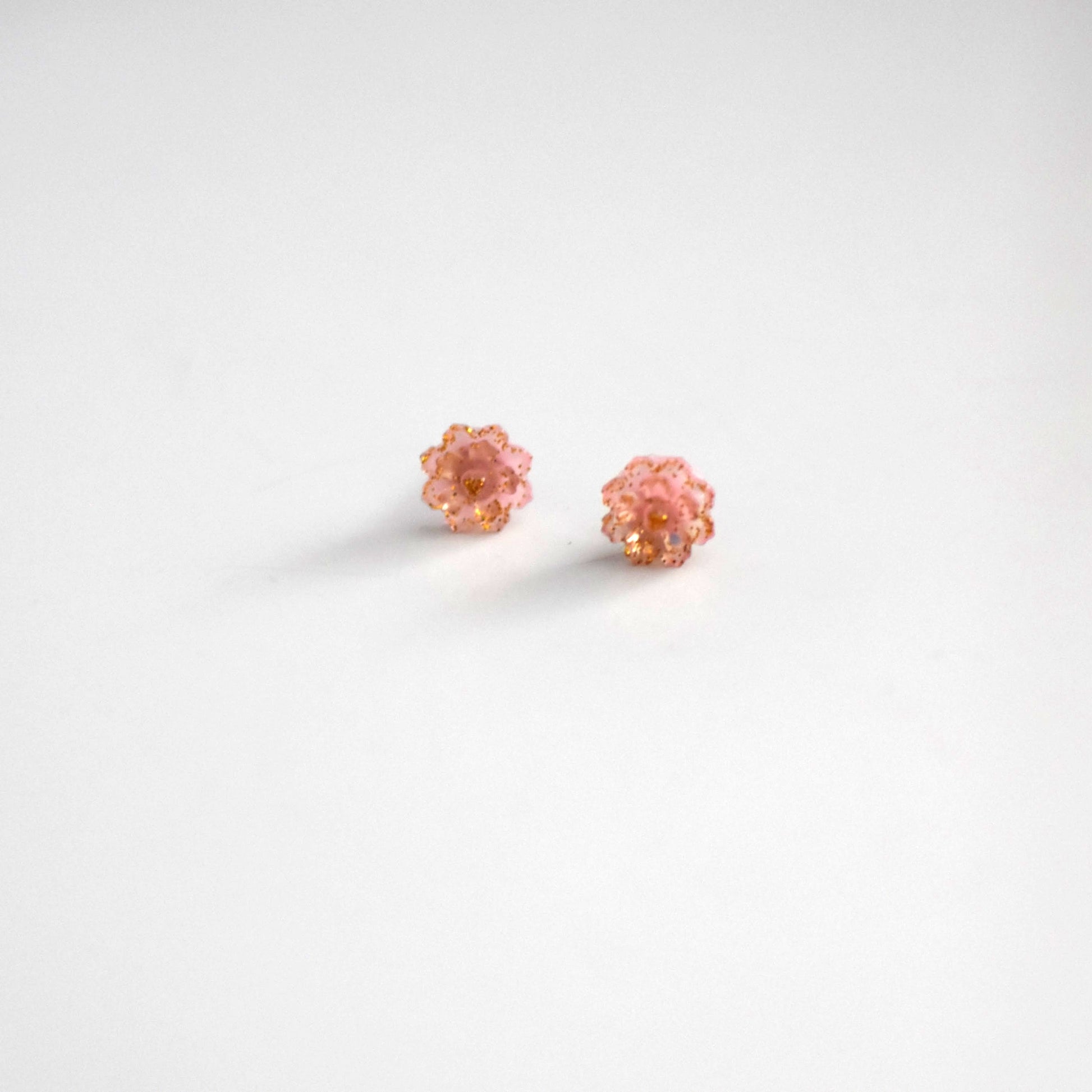 Brai-Glitz-Pair of pink earrings on a white background
