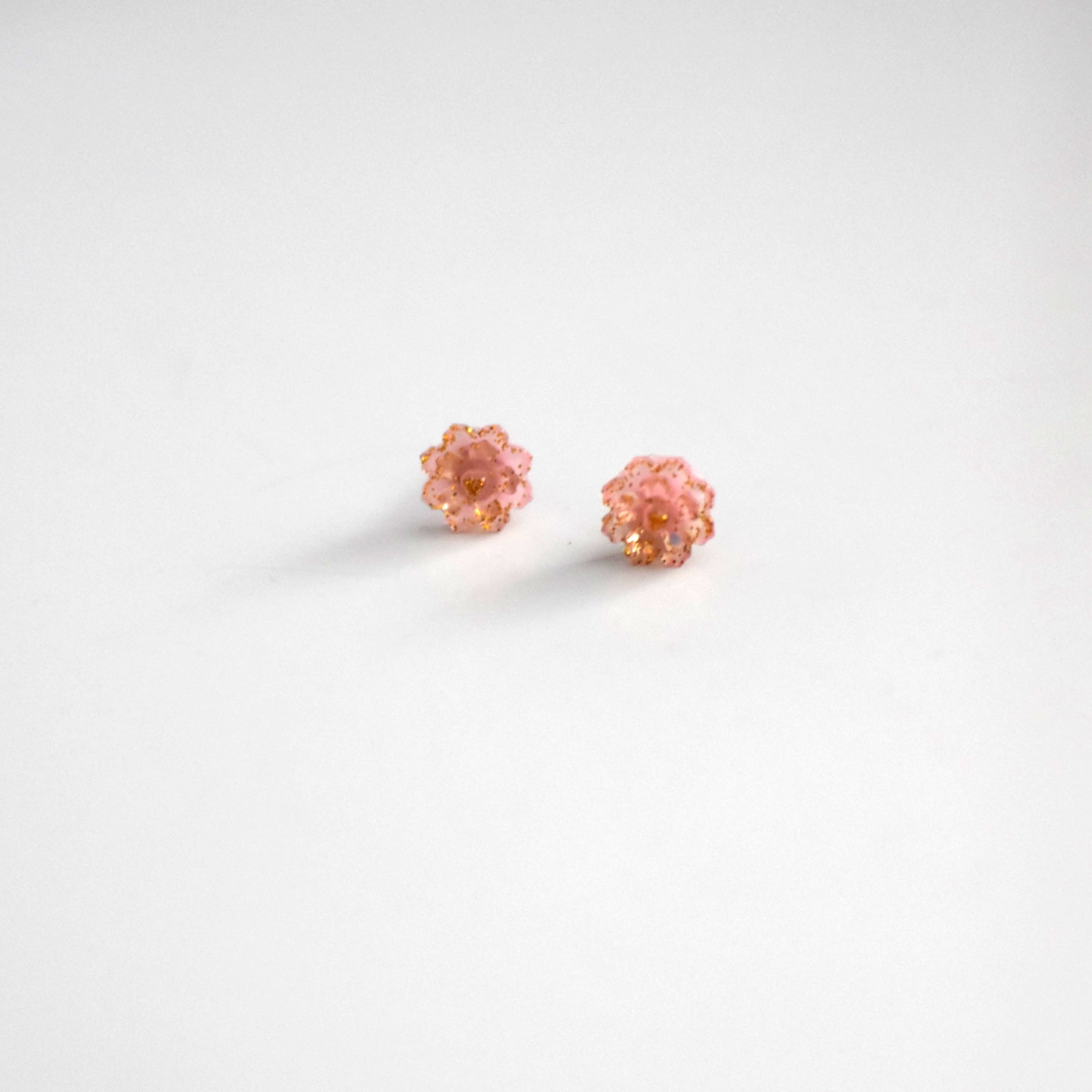 Brai-Glitz-Pair of pink earrings on a white background