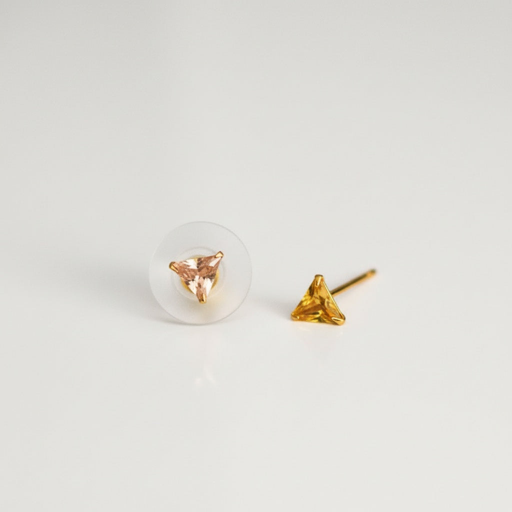 brai-glitz-Gold triangle-shaped earrings on a light gray background
