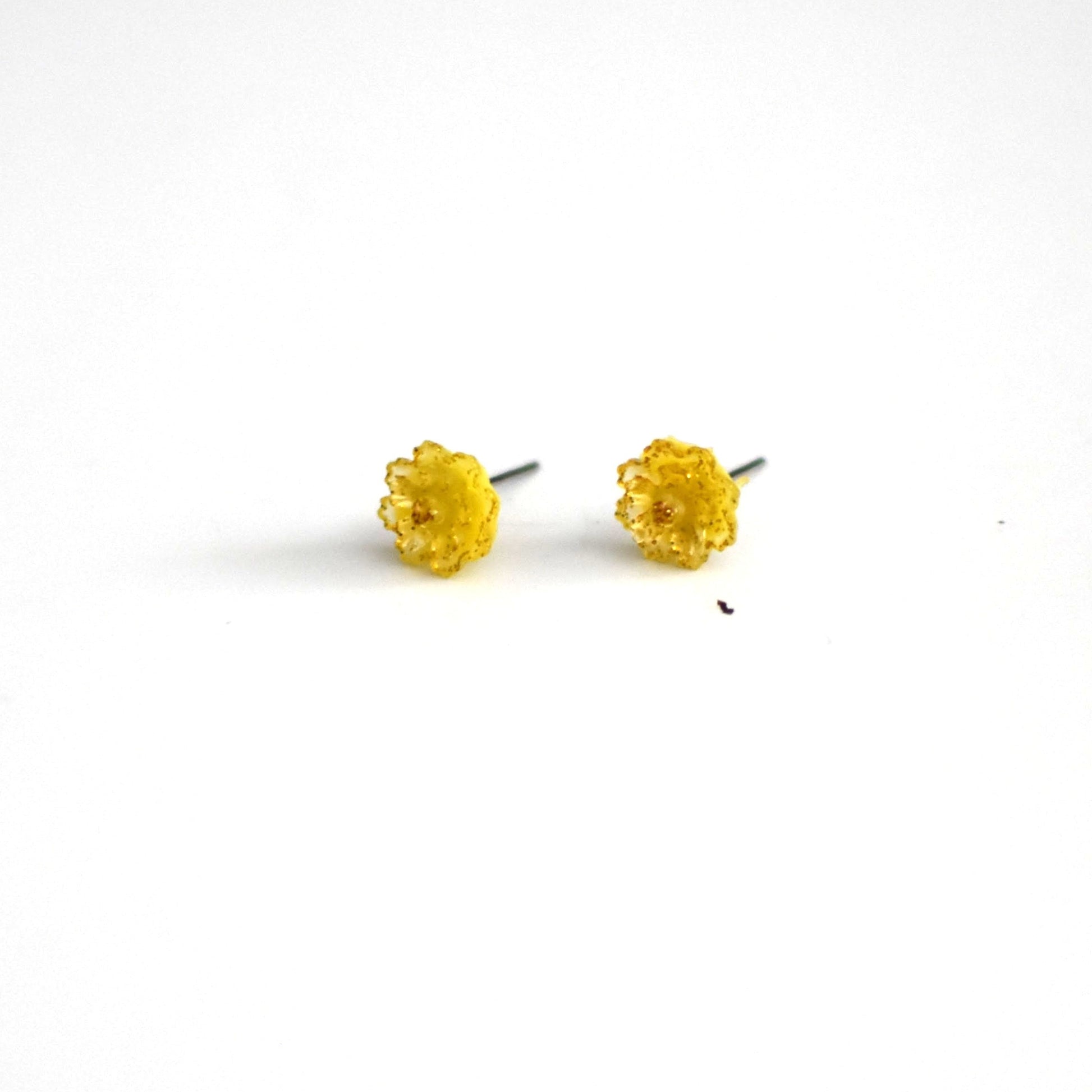 brai-glitz-Pair of yellow stud earrings on a white background
