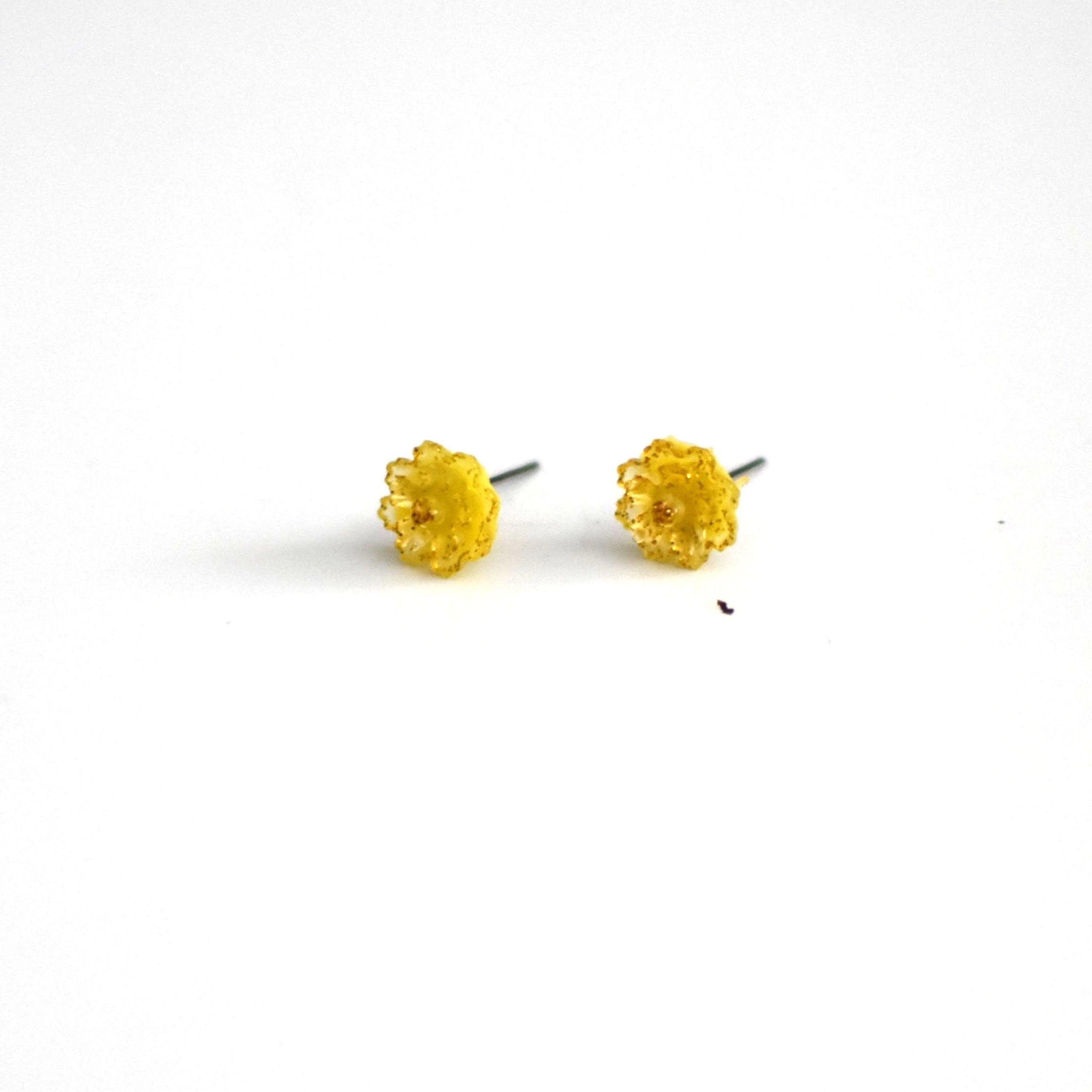 brai-glitz-Pair of yellow stud earrings on a white background